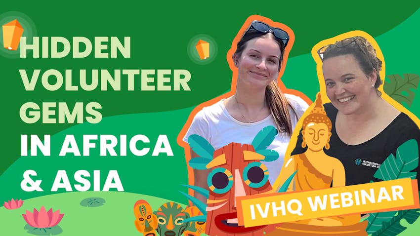 Promotional graphic for an IVHQ webinar on hidden volunteer gems in Africa and Asia. The image features two smiling women, one in a white t-shirt and another in an International Volunteer HQ t-shirt, against a green background decorated with cultural and nature-themed illustrations, including a Buddha figure, tribal mask, lotus flowers, and floating lanterns
